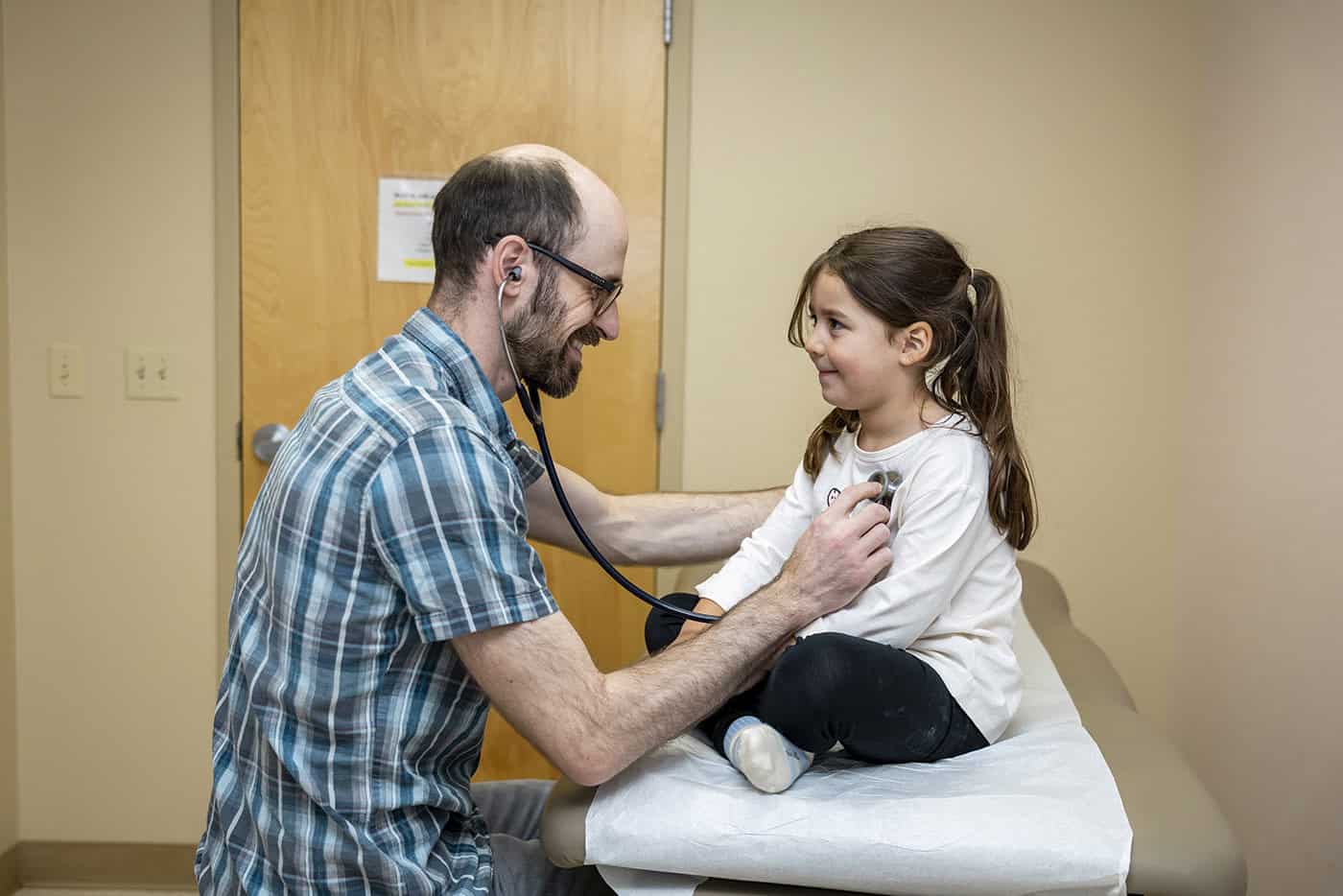 doctor listening to a little girl's heart